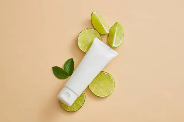 Unlabeled Tube Put Some Lime Slices Leaves Cosmetic Product Mockup — Stock Photo, Image
