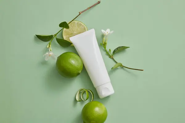 Top View White Tube Empty Label Decorated Some Limes White — Stock Photo, Image