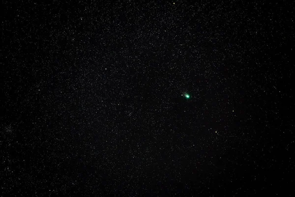 Astrophotography of the tail star or green comet C 2022 E3 ZTF tracked 25 seconds at ISO 2500 in the cold winter night sky with 200mm f2.8 lens on February 7th 2023, near Darmstadt, Germany