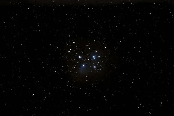 The open star cluster Pleiades M45 with the blue reflection nebula photographed with a telephoto lens near Darmstadt in February 2023