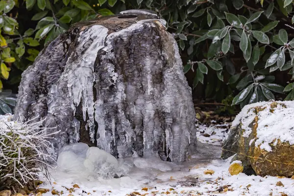 stock image A water stone in the home garden frozen with ice and snow in winter