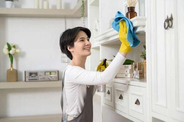 家を掃除するためにアルコールスプレー消毒剤を使用して手袋を掃除しているアジアの女性 健康的なライフスタイルのコンセプト — ストック写真