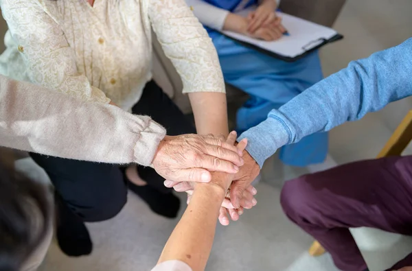 Top view of Seniors people holding  hands together in elder health  care center  , concept of old people health care , group therapy .