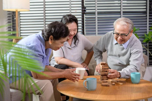 Group of elderly people enjoy talking , relaxing with game at  senior healthcare center.