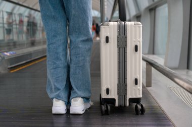 Close-up woman foot walking with suitcase , check in at International airport , vacation travel and transportation concept