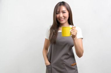 A Portrait of young asian woman wearing apron over white background studio, cooking and entrepreneur concept