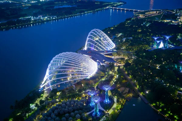 stock image Singapore City, Singapore - dec 27, 2022: Aerial top view of  super tree grove architecture at night in garden landmark by the Bay and Marina Bay Sands hotel . Singapore.