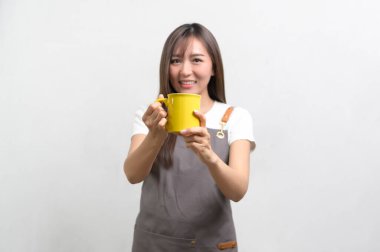 A Portrait of young asian woman wearing apron over white background studio, cooking and entrepreneur concept