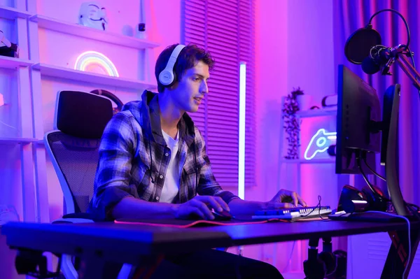 Young Caucasian man Pro Gamer have live streaming  and chatting  with his  fans at home