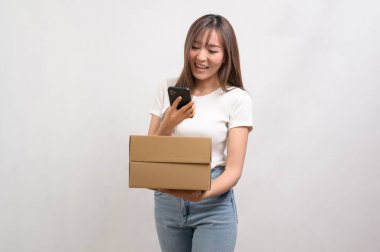 A Young asian woman holding paper box and cardbord box over white background, Save earth and delivery concept clipart