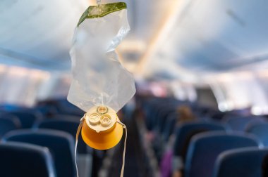 oxygen mask drop from the ceiling compartment on airplane clipart