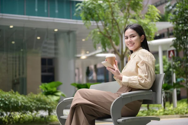 A young businesswoman is working in modern city downtown of Singapore