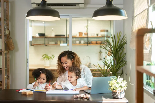 stock image African American mother playing with her daughters in home 