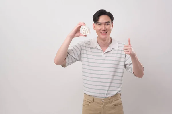Young Smiling Man Holding Small Model House White Background Studio — Stock Photo, Image