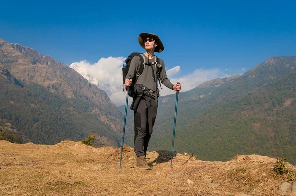 stock image A young traveller trekking on forest trail , Nepal