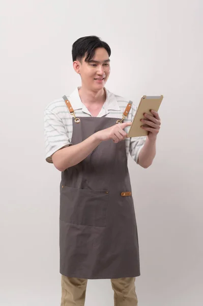 Portrait Young Asian Man Wearing Apron Holding Tablet White Background — Stock Photo, Image
