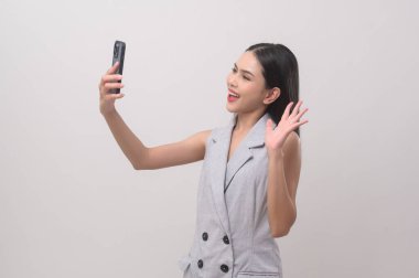 Beautiful woman using smartphone over white background, technology concept. 		