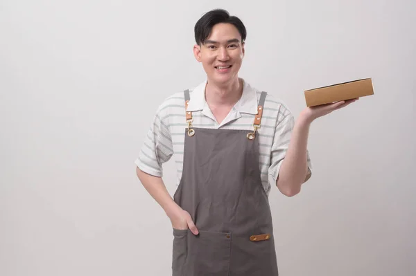 Portrait Young Asian Man Wearing Apron Holding Paper Bag White — Stock Photo, Image