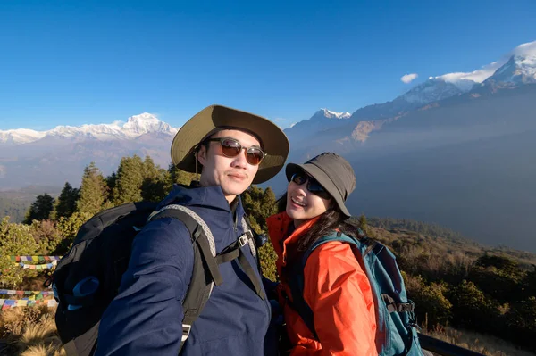 stock image A young couple travellers trekking in Poon Hill view point in Ghorepani, Nepal	