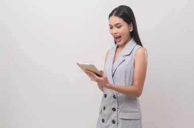 Beautiful woman using tablet over white background, technology concept. 	