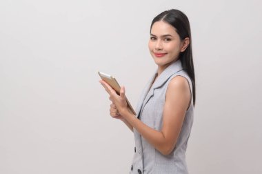 Beautiful woman using tablet over white background, technology concept. 	