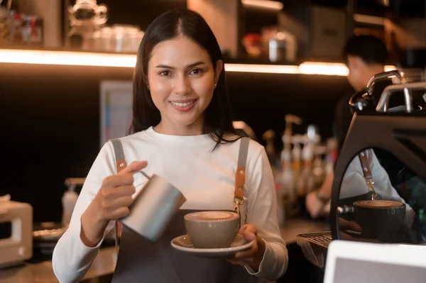 stock image A young woman barista working in modern coffee shop 