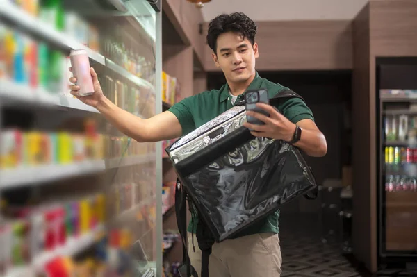 An Asian man delivery choosing goods from online order in supermarket , online delivery service concept