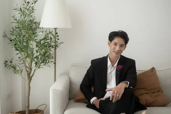 Portrait of young handsome groom in suit, preparing for wedding ceremony
