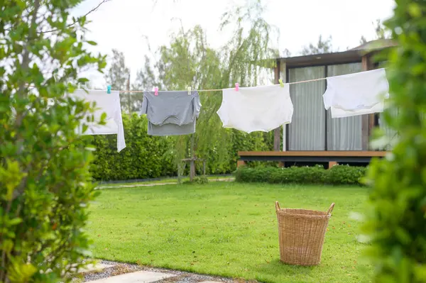 Clothes hanging laundry on washing line for drying against blue sky outdoor