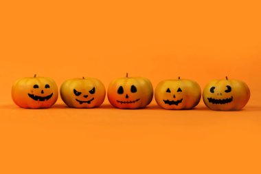 Cadılar Bayramı konsepti komik yüzlü balkabakları, beyaz arkaplanlı fener ve metin için boşluk