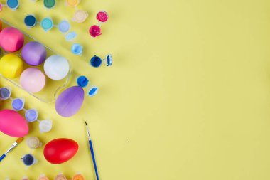 Fırça ve Boyanmış Renkli Paskalya Yumurtaları Metin İçin Yer Olan Sarı Arkaplanda. 