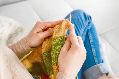 Huzurlu ve rahat bir örgü seansı güzel bir şekilde gösterişli eller canlı bir iplik projesi üzerinde çalışıyor.