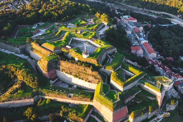 stock image Aerial view of a medieval fortress, panorama of an old fortress covered with green grass at sunset, Poland