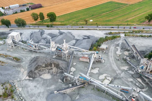 Aerial view of crushing equipment, stone crusher in a quarry, mining equipment for processing and sorting stone, crushed stone, flour