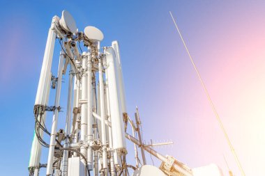 GSM antennas on a high tower against the blue sky, 5g, 4g antennas for cellular communication, close-up plan