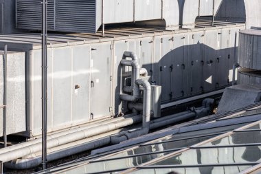 Central air conditioning system on the roof of the building, large shafts for ventilation and cooling of the house