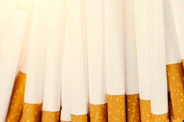 Lots of cigarettes on a pile close up. Harm of smoking