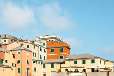 Traditional European architecture in an old mariners' village Boccadasse, Italy. Colorful old buildings on a blue sky background