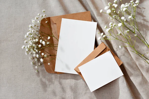 Aesthetic floral business brand template, blank paper cards and envelopes on a neutral beige background, mockup with copy space