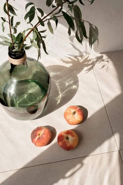 ベージュのリネンのテーブルクロスの背景には 植物や太陽の光の影を持つ緑のガラス瓶で美しいライフスタイルはまだ生活しています 夏のスローライフのコンセプト — ストック写真