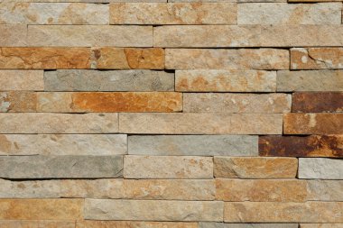 Modern otantik bej, kahverengi ve gri taş duvar dokusu arka planı. Kırsal mimari bina cephesi, evin dış duvarı.