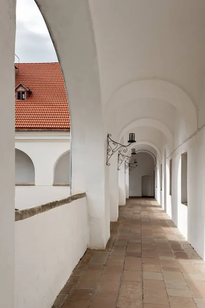 Aesthetic neutral beige architecture building background with arch gallery corridor. Old historical European building exterior design, archway.