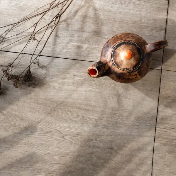 精致简约的茶壶 木制桌子背景 干草和阳光阴影 可持续的陶器 瓦比萨比概念 复制空间 — 图库照片