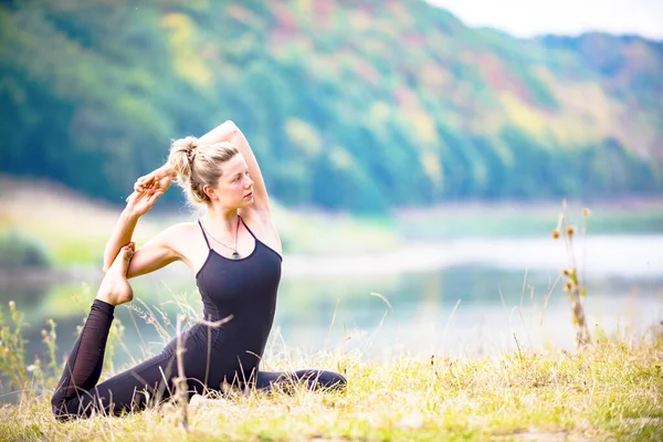 stock image yoga girl on the bank of the Dniester river. Ukraine. August 28, 2019