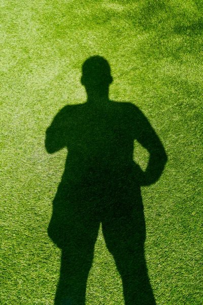 Shadow of a man on the grass, artificial grass