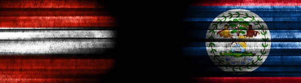 オーストリアとベリーズの黒い背景の旗 — ストック写真