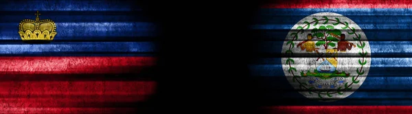 リヒテンシュタインとベリーズの黒い背景の旗 — ストック写真