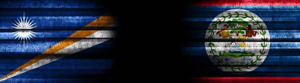 マーシャル諸島とベリーズの黒い背景の旗 — ストック写真