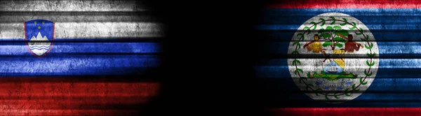 ブラックバックグラウンドのスロベニアとベリーズの旗 — ストック写真