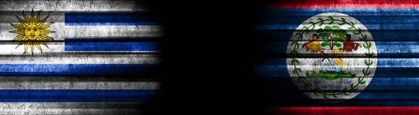 黒い背景のウルグアイとベリーズの旗 — ストック写真
